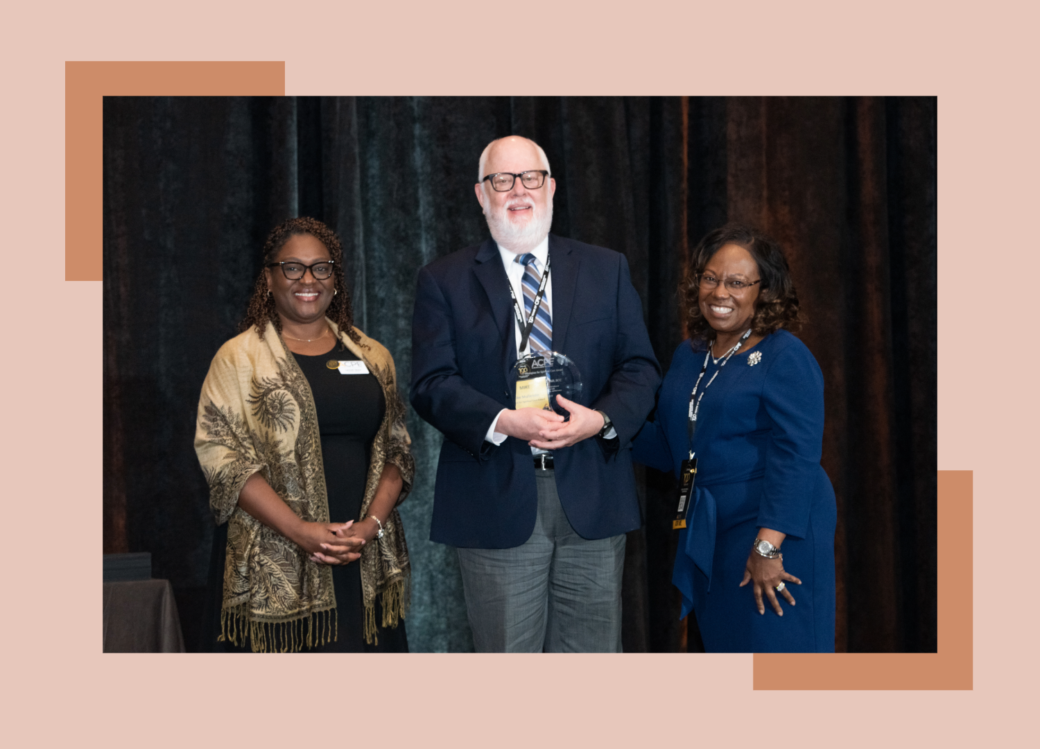 Image of older gentleman receiving award at a conference.