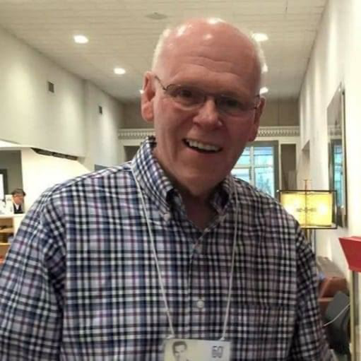 Ken looks at camera smiling