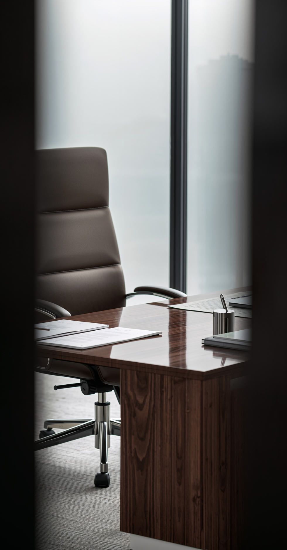 empty office chair behind a wooden desk